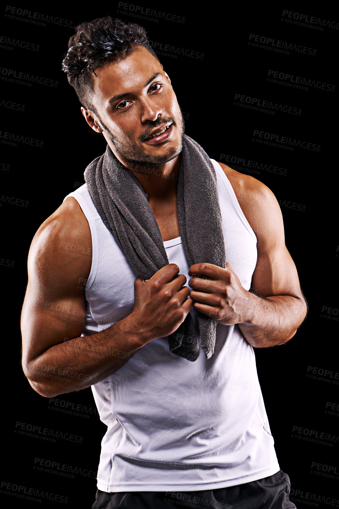 Buy stock photo Studio portrait of a handsome young man in sportswear standing with a towel around his neck