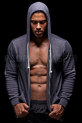 Buy stock photo Studio shot of a muscular young man wearing a hoodie isolated on black