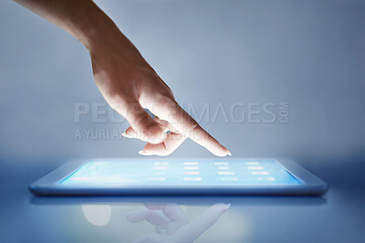 Buy stock photo Cropped closeup of a woman's hand above a digital tablet