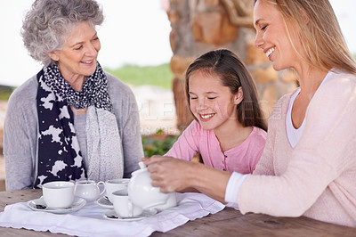 Buy stock photo Woman, child and relax with tea for fun, generations in park together for bonding with love. Family time, mother and happy grandma and smile for summer garden picnic, cups and teapot for beverage