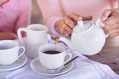Buy stock photo Shot of a woman pouring coffee