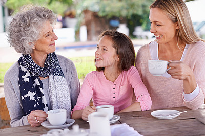 Buy stock photo Shot of three generations of the woman of the women of a family having tea outside