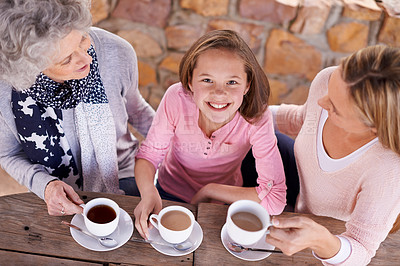 Buy stock photo Portrait, women or girl to relax, family or tea to share, wisdom or visit as bonding together. Grandma, mother or female child as smile, drink or retirement at outdoor coffee shop or park table