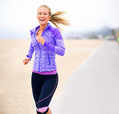 Buy stock photo Portrait of a young woman jogging near the beach