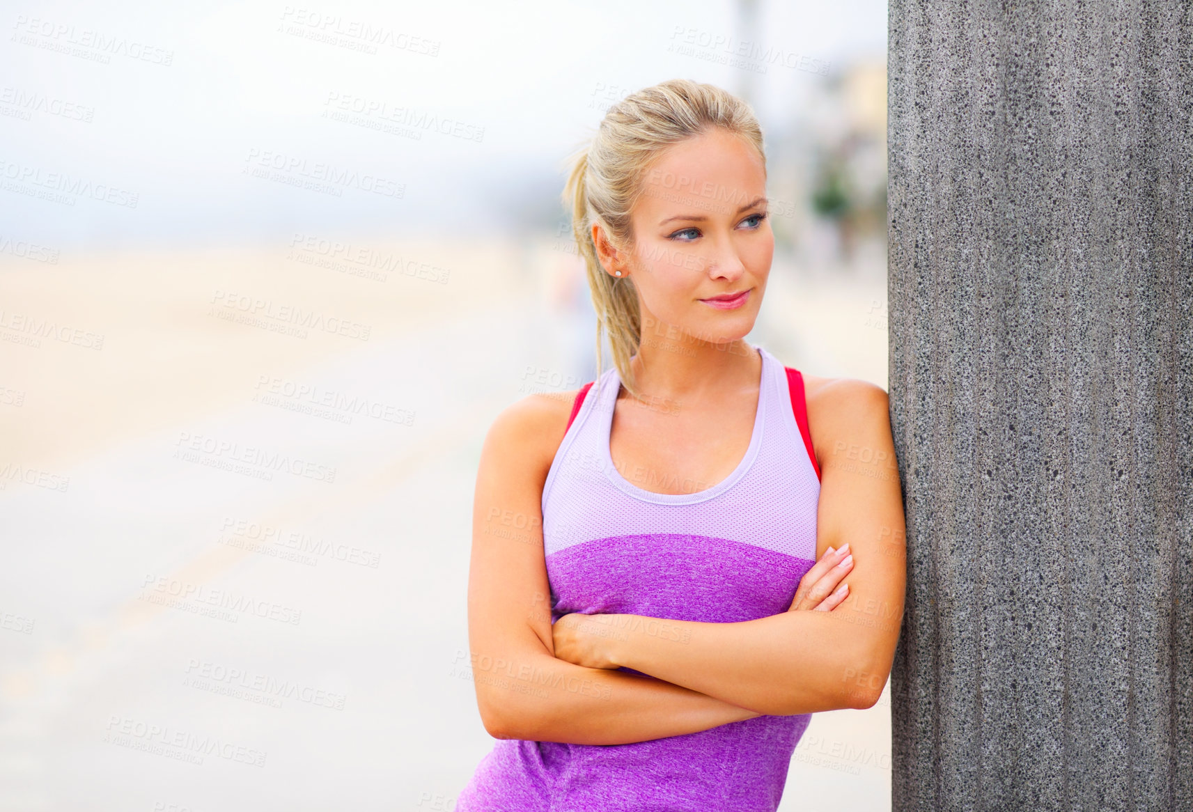 Buy stock photo Portrait of a young woman in sportswear standing at the beach