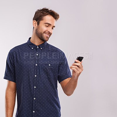 Buy stock photo Phone, communication and man networking in studio, background and social media in mockup space. Happy, businessman and reading email on smartphone with news, information or scroll search on internet
