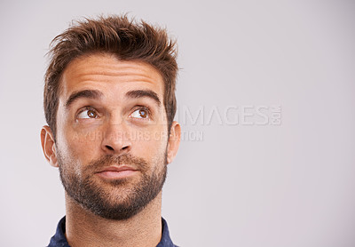 Buy stock photo Studio shot of a handsome young man looking up