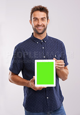 Buy stock photo Businessman, portrait and green screen on tablet in studio mockup, news and promotion for technology company. Designer, happy face or touchscreen for space or deal or digital tech by grey background