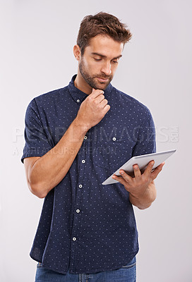 Buy stock photo Business man, studio and online research on tablet with thinking, planning and problem solving for project. Designer, creative idea or touchscreen for fashion prototype or digital by grey background