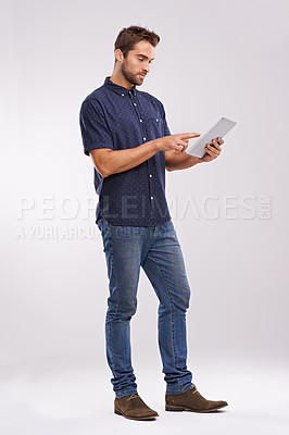 Buy stock photo Man, tablet and scroll with internet connection in studio for website technology for connectivity, online or white background. Male person, network and digital browsing for email, streaming or mockup