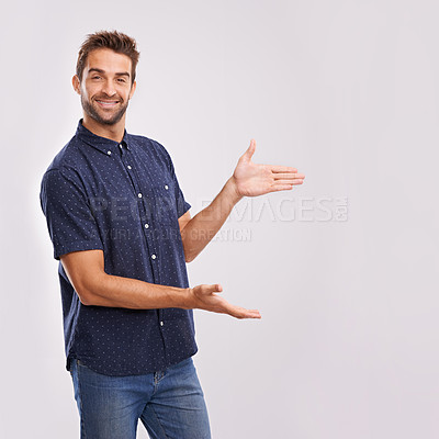 Buy stock photo Happy man, studio and portrait with pointing to mockup and hand gesture for sign or advertising. Model, face and positive for show to choice or copy space, information and branding by grey background