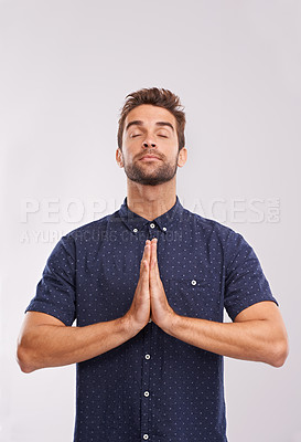 Buy stock photo Young man, studio and hands together in prayer, trust and hope in religion by grey background. Entrepreneur, gratitude or asking god for direction or blessing, guidance or worship in christian faith