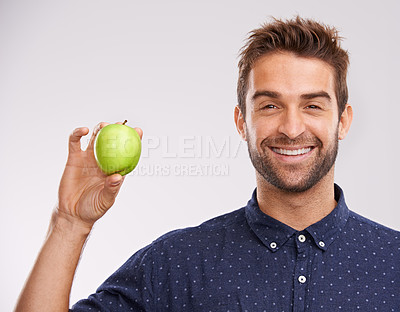 Buy stock photo Studio, smile and portrait of man with apple for nutrition, healthy diet and weight loss. Green fruit, organic food and man with happiness for detox, self care and vitamin c on white background