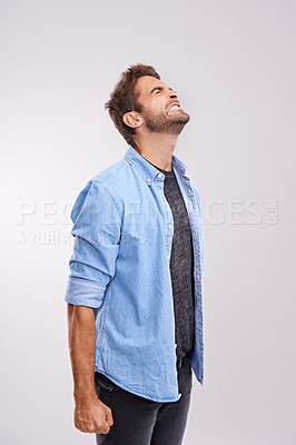 Buy stock photo Upset, angry and frustrated with man, stress and facial expression on a grey studio background. Body language, person and model with emotions and burnout with anxiety and anger with crisis or mistake