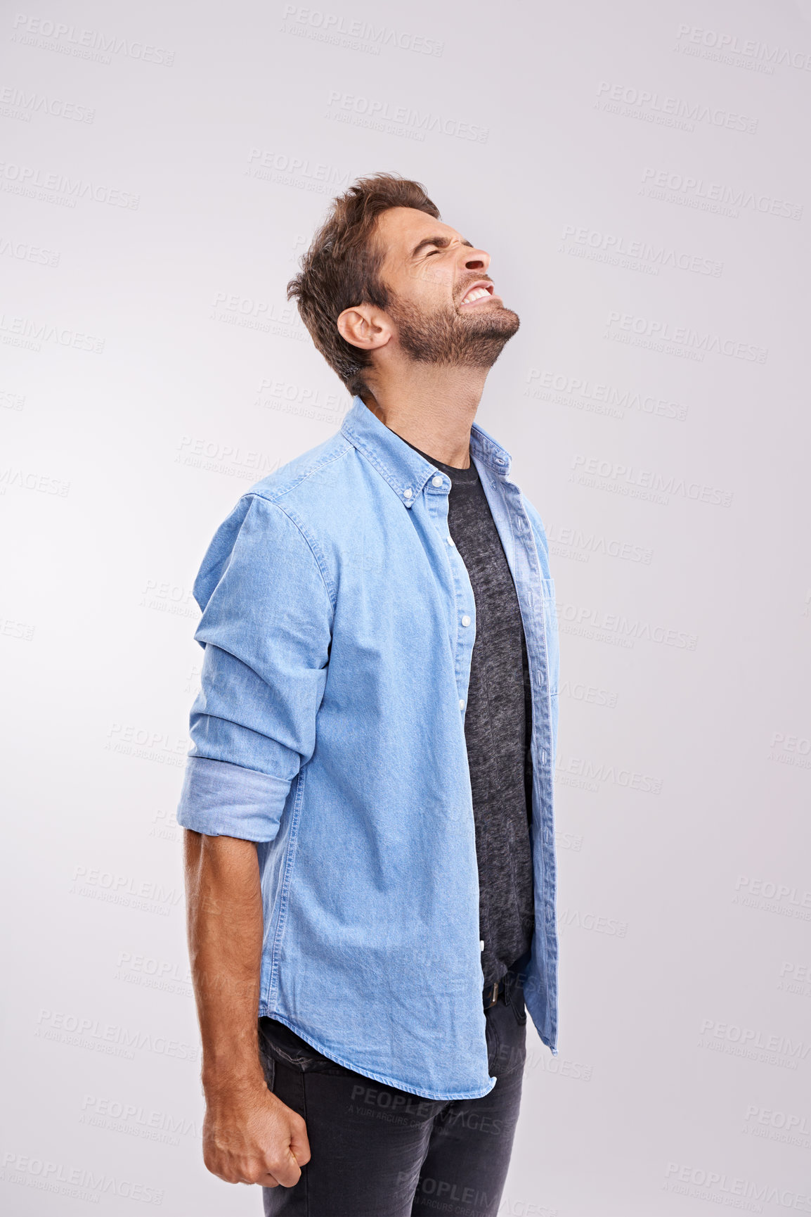 Buy stock photo Upset, angry and frustrated with man, stress and facial expression on a grey studio background. Body language, person and model with emotions and burnout with anxiety and anger with crisis or mistake