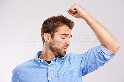 Buy stock photo Man, smell armpit and sweat stain, bad hygiene or body odor with stink isolated on white background. Hyperhidrosis, poor hygiene and dirty, foul or negative with disgust for underarm in studio