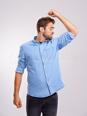 Buy stock photo Man, smelling armpit and sweat stain, bad hygiene or body odor with stink isolated on white background. Hyperhidrosis, poor hygiene and dirty, foul or negative with disgust for underarm in studio
