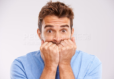 Buy stock photo Portrait, bite nails and man with anxiety, stress and worried with guy isolated on a grey studio background. Face, male person and human with depression, mental health problem and scared with doubt
