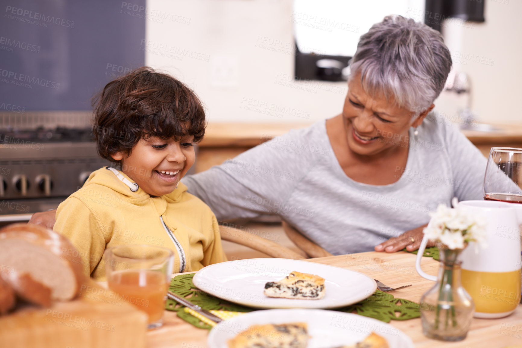 Buy stock photo Happy grandmother, grandchild and food with family for thanksgiving, dinner or meal together at home. Grandma and little boy with smile at dining table in happiness for holiday weekend or bonding