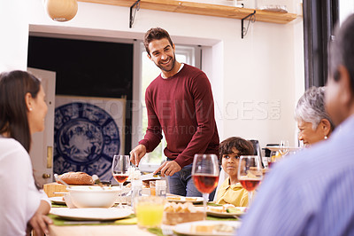 Buy stock photo Man, serve and food in house for family, wine and party for lunch, feast and gathering or drink. Diverse people and happy with juice and cutlery for dish, glassware and table in home for visit