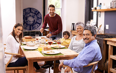 Buy stock photo A happy man serving lunch to his family
