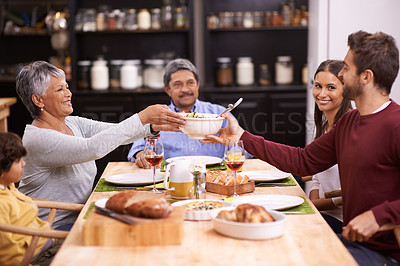 Buy stock photo A shot of a happy family sharing a meal together