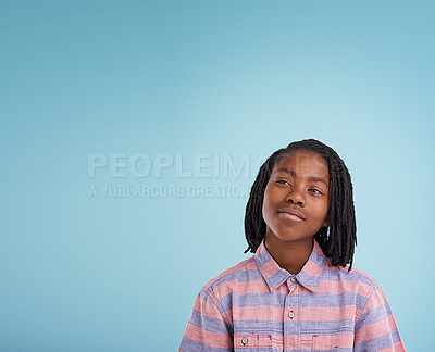 Buy stock photo Shot of a thoughtful young boy standing in studio