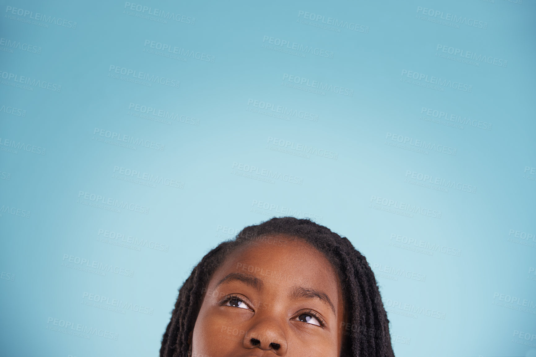 Buy stock photo Cropped studio shot of a thoughtful young boy against a blue background