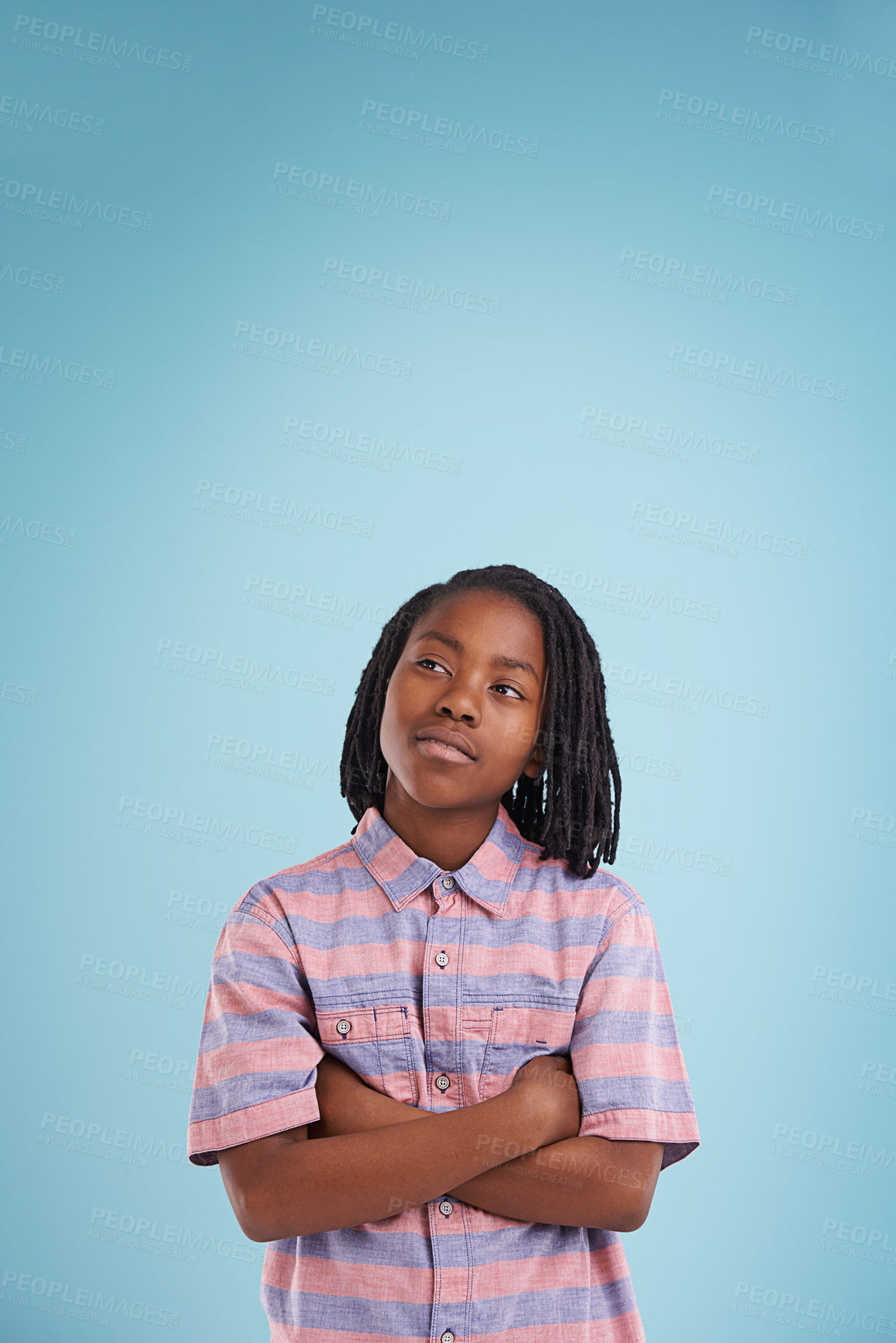 Buy stock photo Boy, thinking or black child with arms crossed in studio for question, memory or reflection on blue background. Brainstorming, remember or African teen model with vision for solution, why or guess