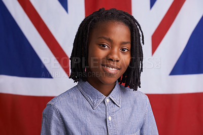 Buy stock photo Kid, portrait and happy with UK flag or backdrop for citizenship, government and human rights. Smile and face of black child, student or boy from united kingdom and Union Jack background for support