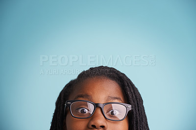 Buy stock photo Vision, glasses or black kid with wow eyes in studio for eyecare, wellness or optometry on blue background. Frame, mockup or teen male model face with eyesight, prescription or ophthalmology testing 