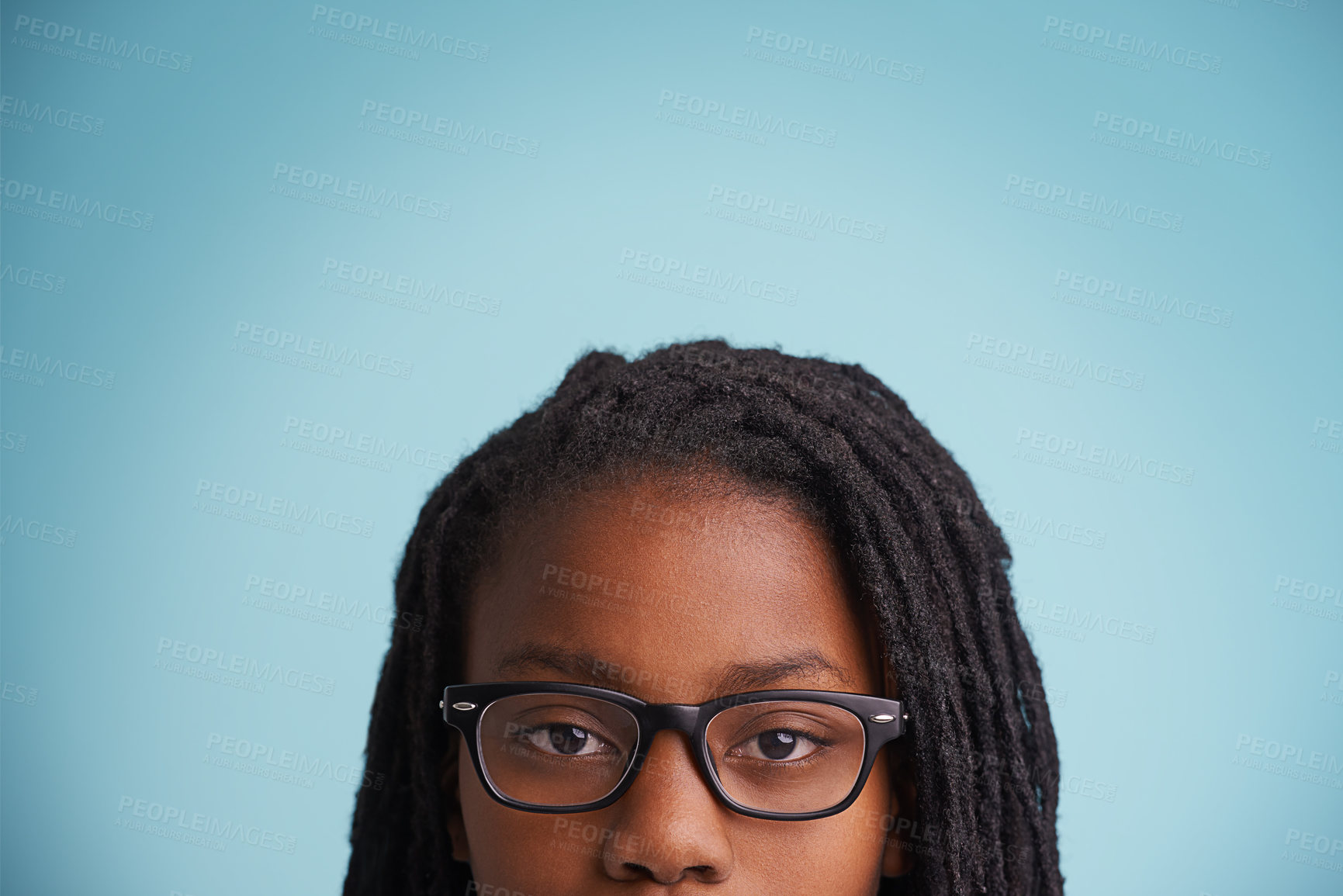 Buy stock photo Vision, glasses or black kid in studio for eye care, wellness or optometry on blue background. Frame, mockup or closeup of African teen male model with eyesight, prescription or ophthalmology testing