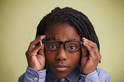 Buy stock photo Glasses, vision and boy kid portrait in studio for eye care, wellness or optometry on green background. Frame, mockup or face of teen male model with eyesight, prescription or ophthalmology testing