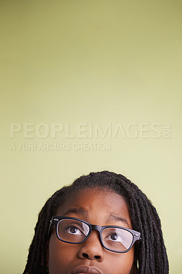 Buy stock photo Teenager, glasses and looking up in studio of education, learning and knowledge on a green background. Boy, child or student thinking, vision and creative ideas or reading information on mockup space