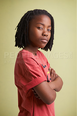 Buy stock photo Fashion, children and portrait of black boy in studio with arms crossed in confidence on green background. Mockup, face and African teen model pose with attitude, style or cool outfit choice