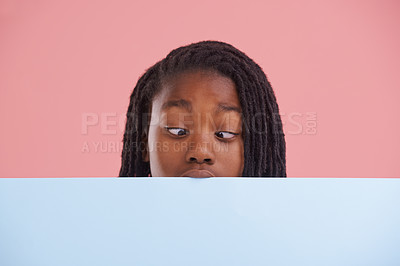 Buy stock photo Poster, funny or boy child with cross eyes on mockup in studio for announcement, offer or info on pink background. Banner, comic or teen model with billboard presentation for silly, news or promo