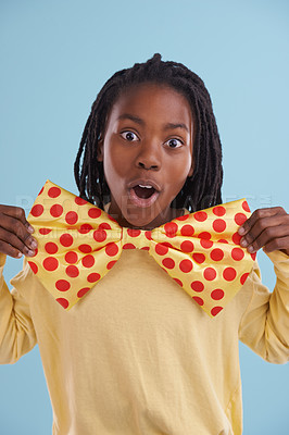 Buy stock photo Child, bowtie and portrait in studio for costume, clothes and fashion for silly, comic and bold with dots. African boy or tween and wow expression for cosplay, crazy and funny for joy and dress up  