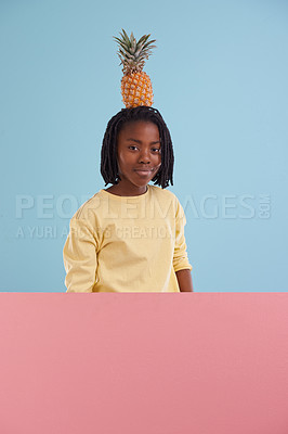 Buy stock photo Portrait, banner or boy child with pineapple in studio for health, wellness or gut health on blue background, Fruit, balance or face of African teen model with organic diet poster, nutrition or detox