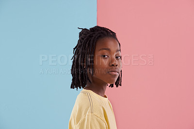 Buy stock photo African teenager, portrait and fashion in studio with creative color, style and blue and pink background. Face of young and cool person, model or boy in natural hair and casual clothes with pastel 