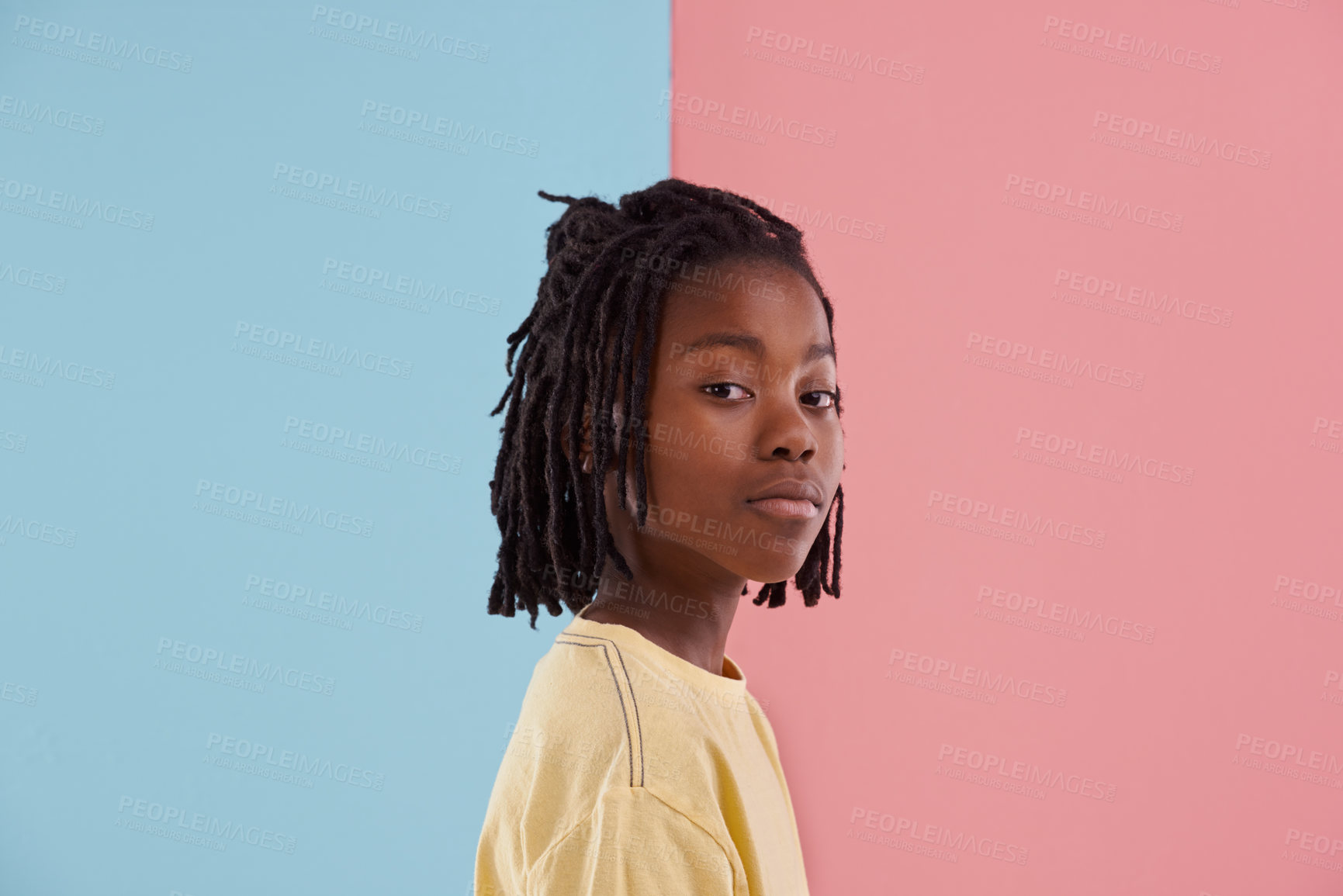 Buy stock photo African teenager, portrait and fashion in studio with creative color, style and blue and pink background. Face of young and cool person, model or boy in natural hair and casual clothes with pastel 