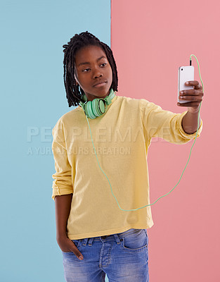 Buy stock photo Teen, boy and selfie of student in studio with headphones for listening to music in high school with fashion. Colorblock, mockup and post on social media with confidence and pride in profile picture