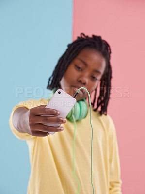 Buy stock photo Teen, student and selfie of boy in studio with headphones for listening to music with lgbt youth in high school. Trans, blog and post on social media about queer identity and pride in profile picture