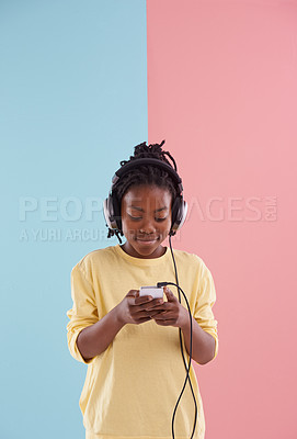 Buy stock photo Teen, boy and relax with phone and headphones in studio for listening to music in high school and reading. Happy, kid and creative post on social media with audio and watch live stream on app