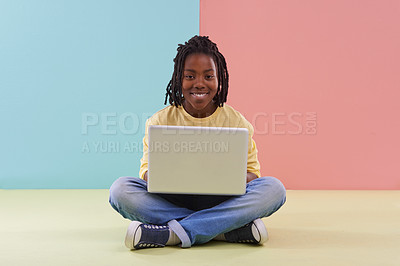 Buy stock photo Studio portrait of a young boy sitting with his laptop