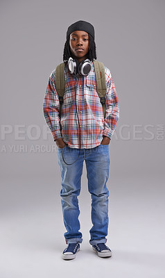 Buy stock photo Headphones, fashion and portrait of child on gray background for listening to song, audio and radio. Student, school and young African boy with bag in trendy style, clothes and outfit in studio