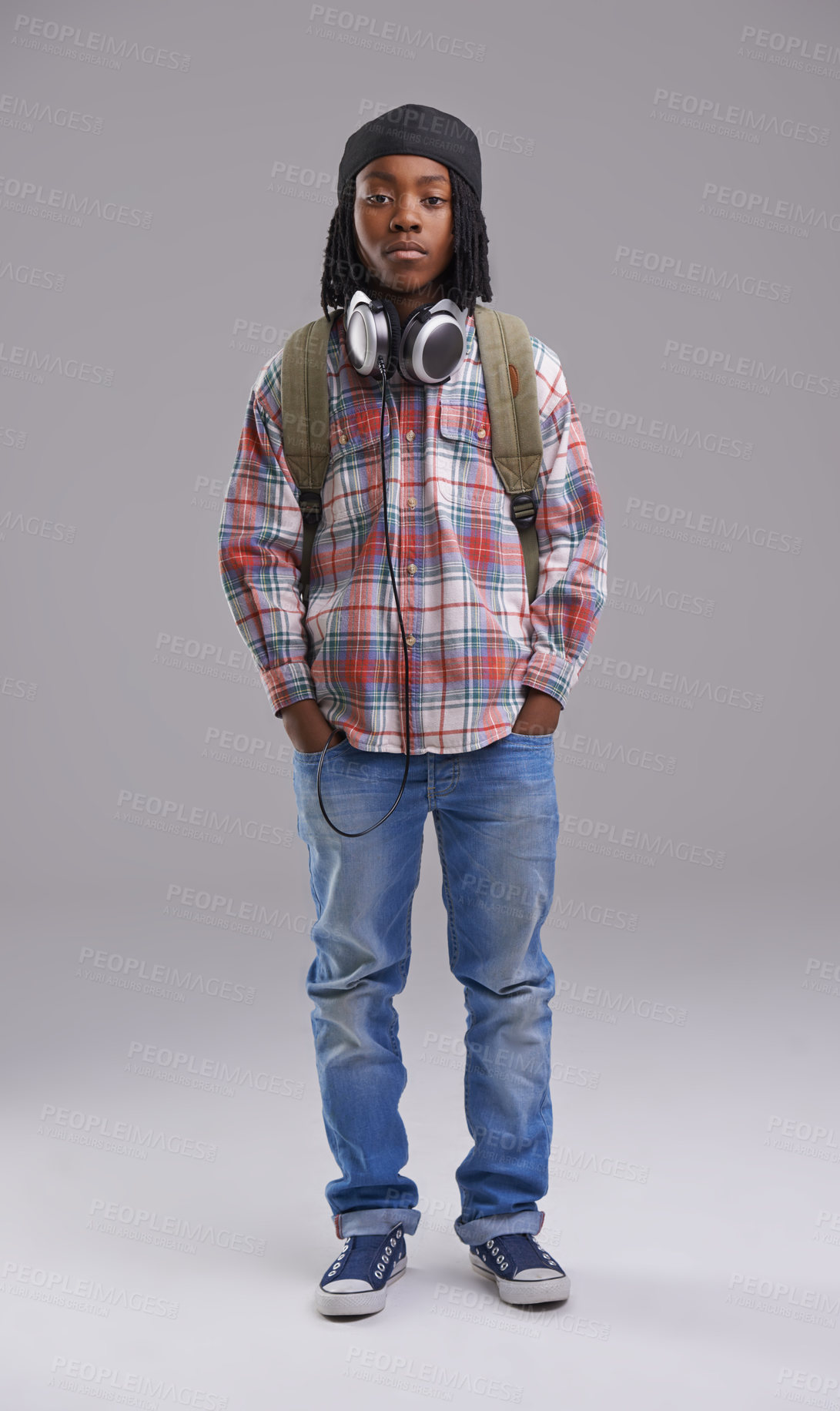 Buy stock photo Headphones, fashion and portrait of child on gray background for listening to song, audio and radio. Student, school and young African boy with bag in trendy style, clothes and outfit in studio