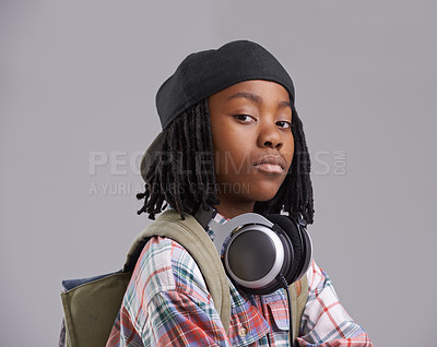 Buy stock photo Attitude, headphones and portrait of child on gray background with headphones for song, audio and radio. Fashion, school and young African boy with bag in trendy style, clothes and outfit in studio