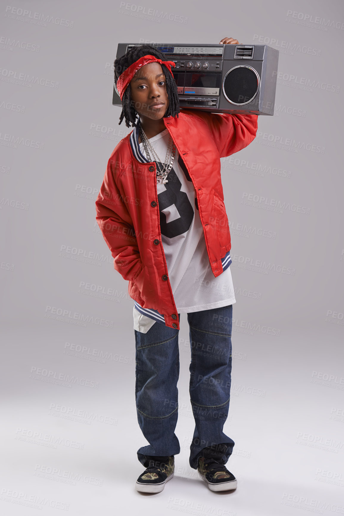 Buy stock photo African boy, hip hop and fashion portrait with radio for rap music and dance in a studio with urban clothing. Black kid and boombox with trendy clothes and swag with confidence and grey background