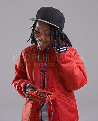 Buy stock photo Music, happy and child on gray background with cassette for listening to song, audio and radio. Fashion, youth and young African boy with retro tech for track playlist in trendy clothes in studio