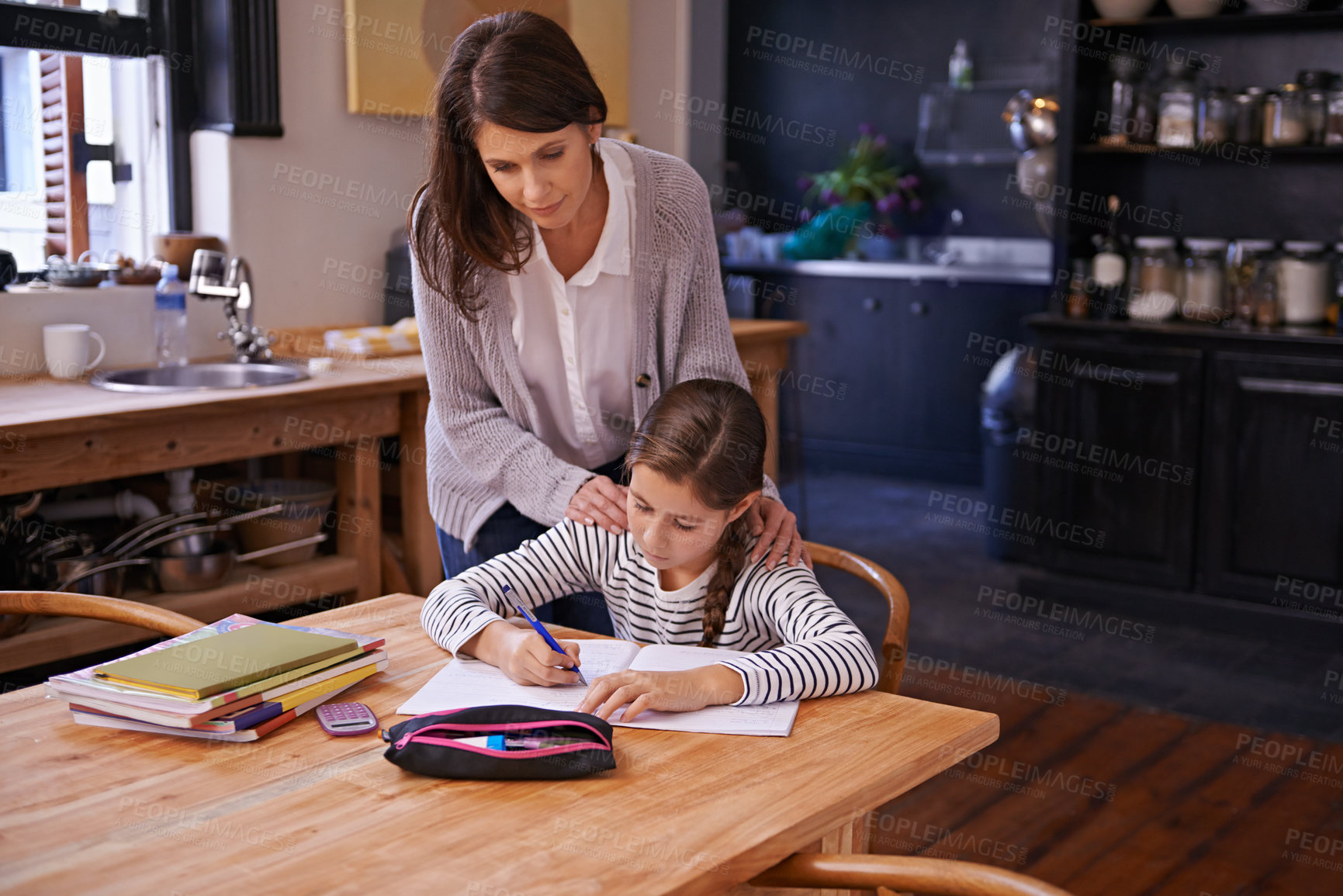 Buy stock photo Studying, mother and girl with books for help, advice and check for homework with education. Mom, daughter and notebook with drawing, notes and development with learning in kitchen at family house